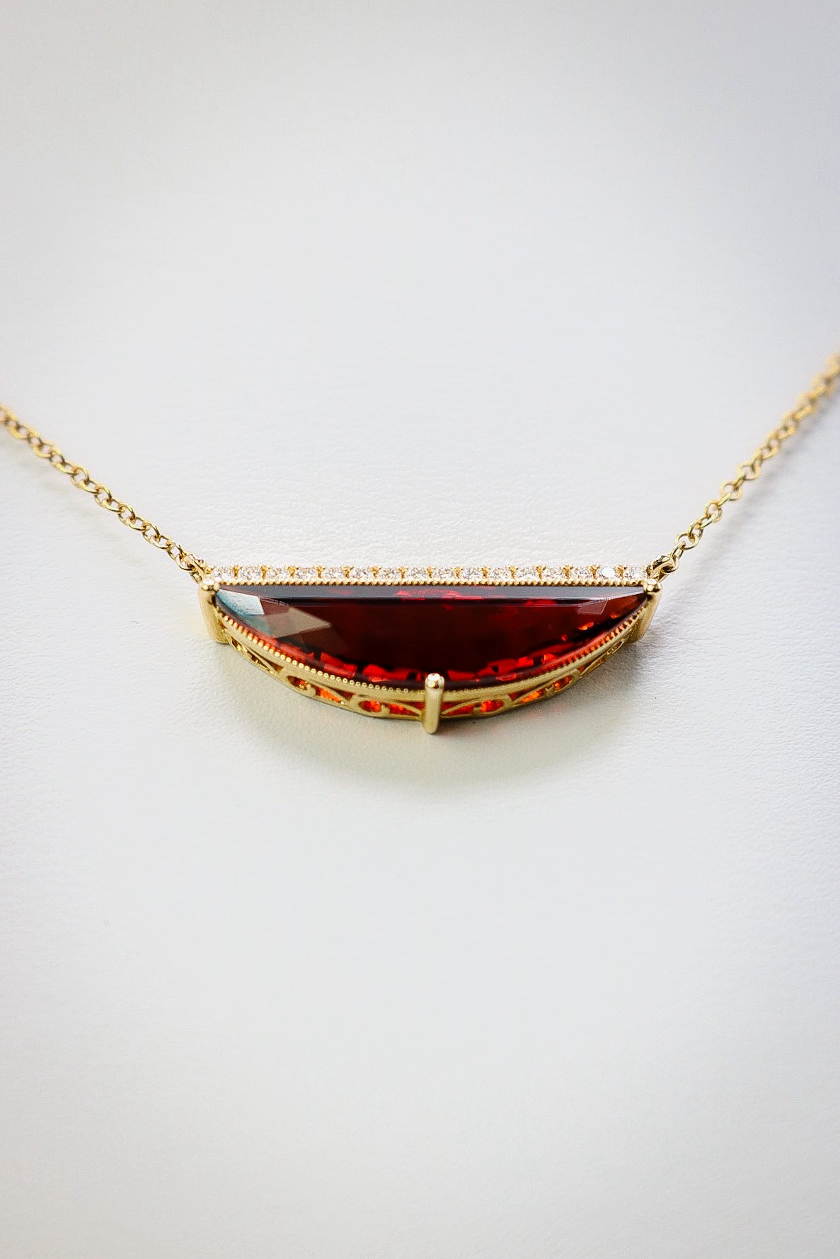 Half-moon garnet and diamond bar necklace in gold filigree setting