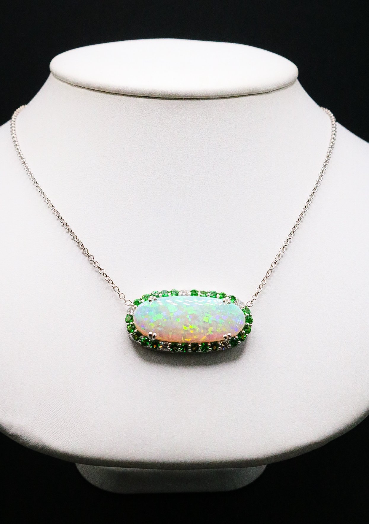 Oval opal necklace with green garnet and diamond halo on white gold chain