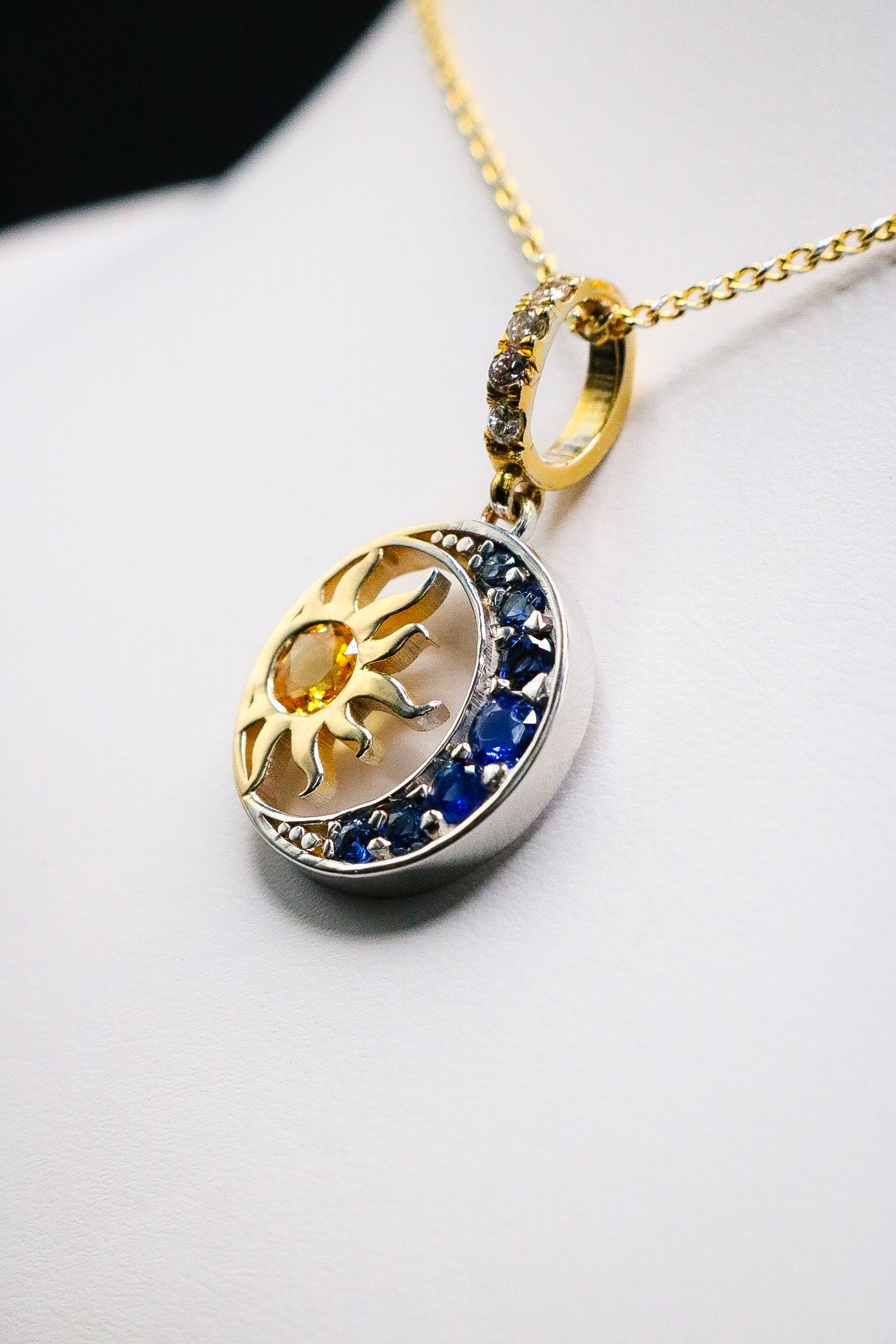 Sun and crescent moon pendant with yellow and blue sapphires on gold chain