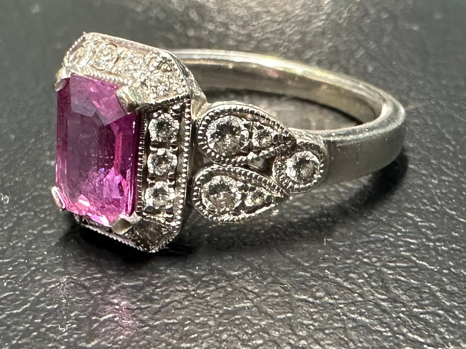 Customer photo: pink sapphire engagement ring with diamond details in white gold, from Erin's Google review