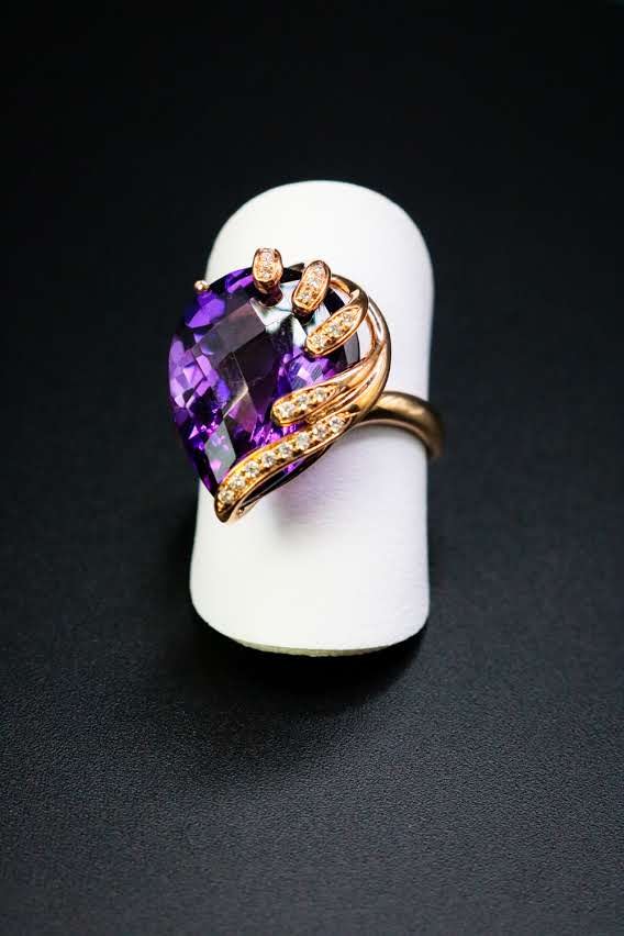 Large pear-cut amethyst ring wrapped in rose gold vines with diamonds